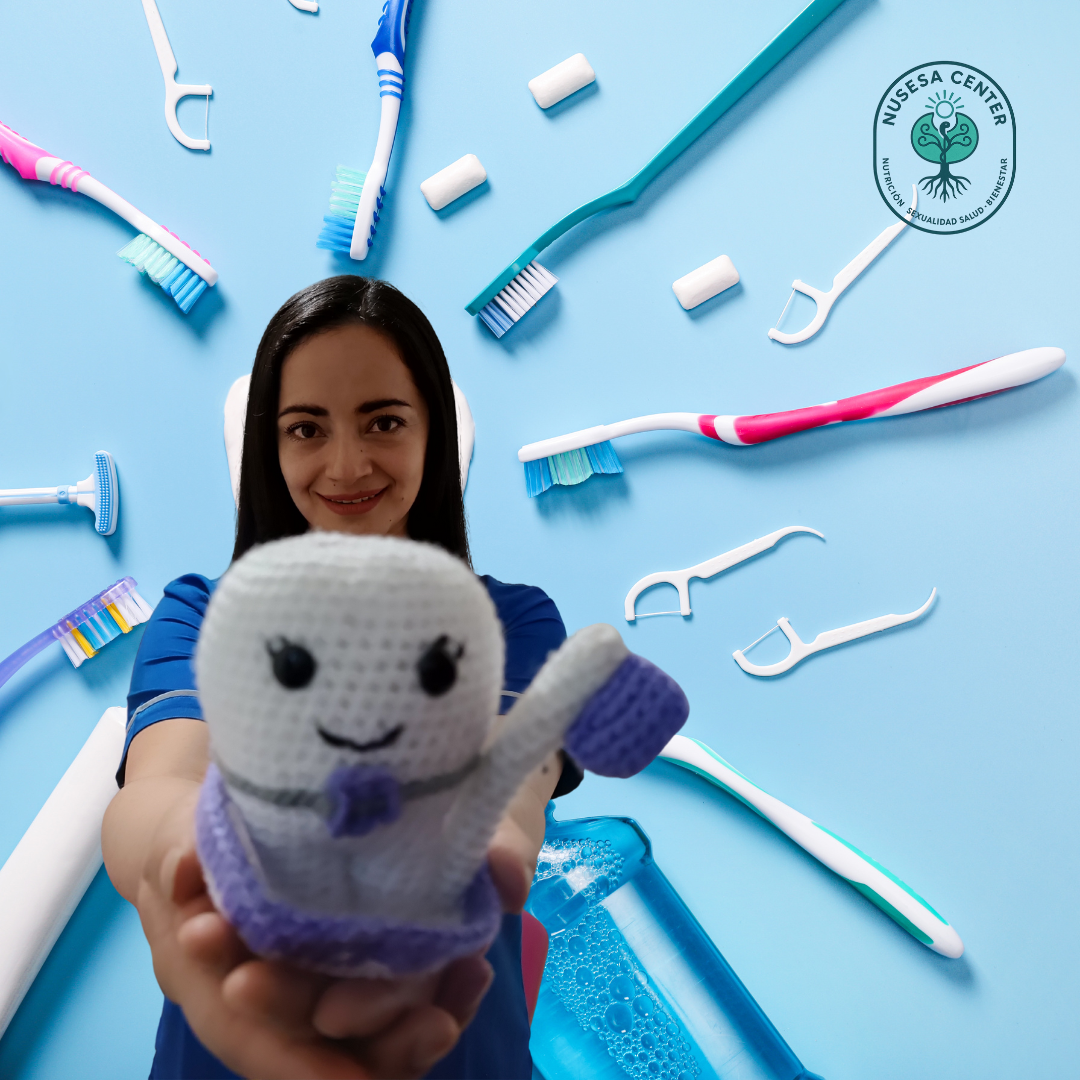 Mujer odontóloga sosteniendo modelo dental, fondo azul, imagen representativa de Dra. Jenn, salud dental integral NUSESA Center.